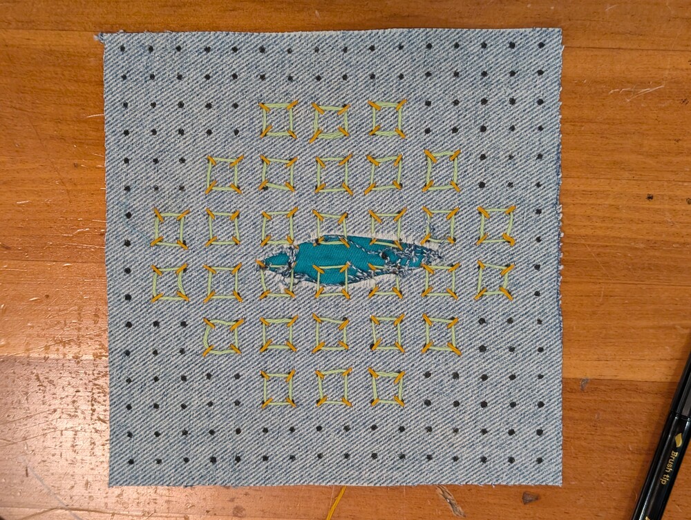 Sashiko sample showing a repair with a box pattern