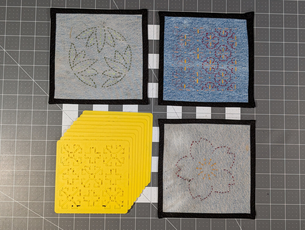 Several decorative Sashiko samples and a stack of Sashiko templates