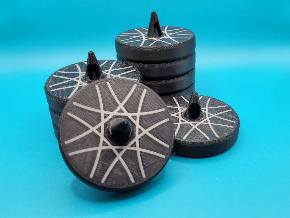 Stack of sewing weights with a silver accent inlay