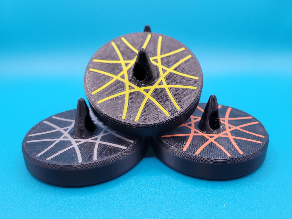 Stack of sewing weights with various colors of accent inlays