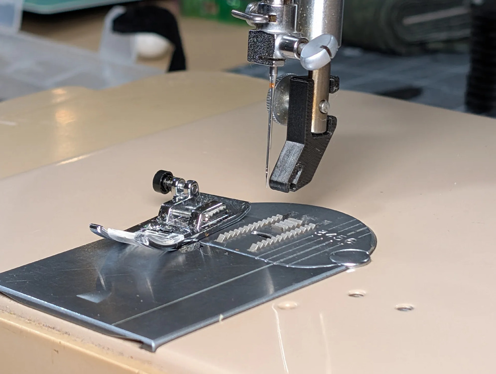 Original slant-shank foot removed, sitting next to the adapter